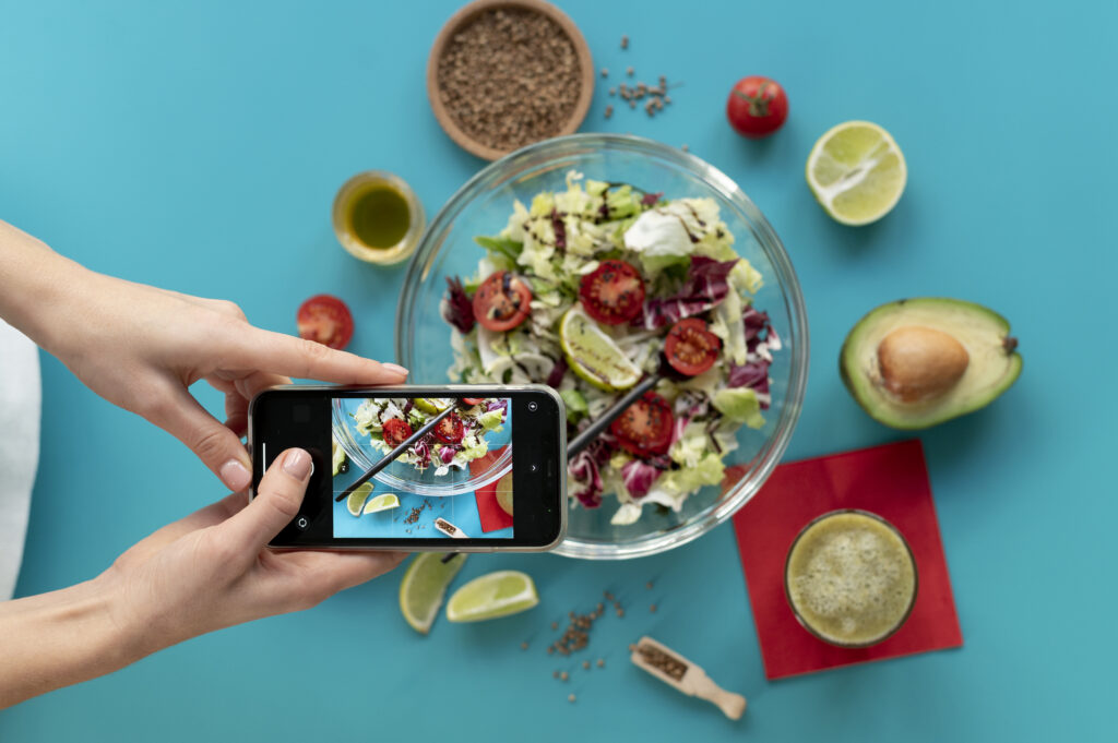 woman-taking-photo-bowl-with-salad-fork