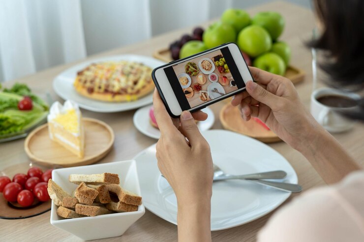 woman-uses-smartphone-take-pictures-food-table-check-social-media_112699-1737